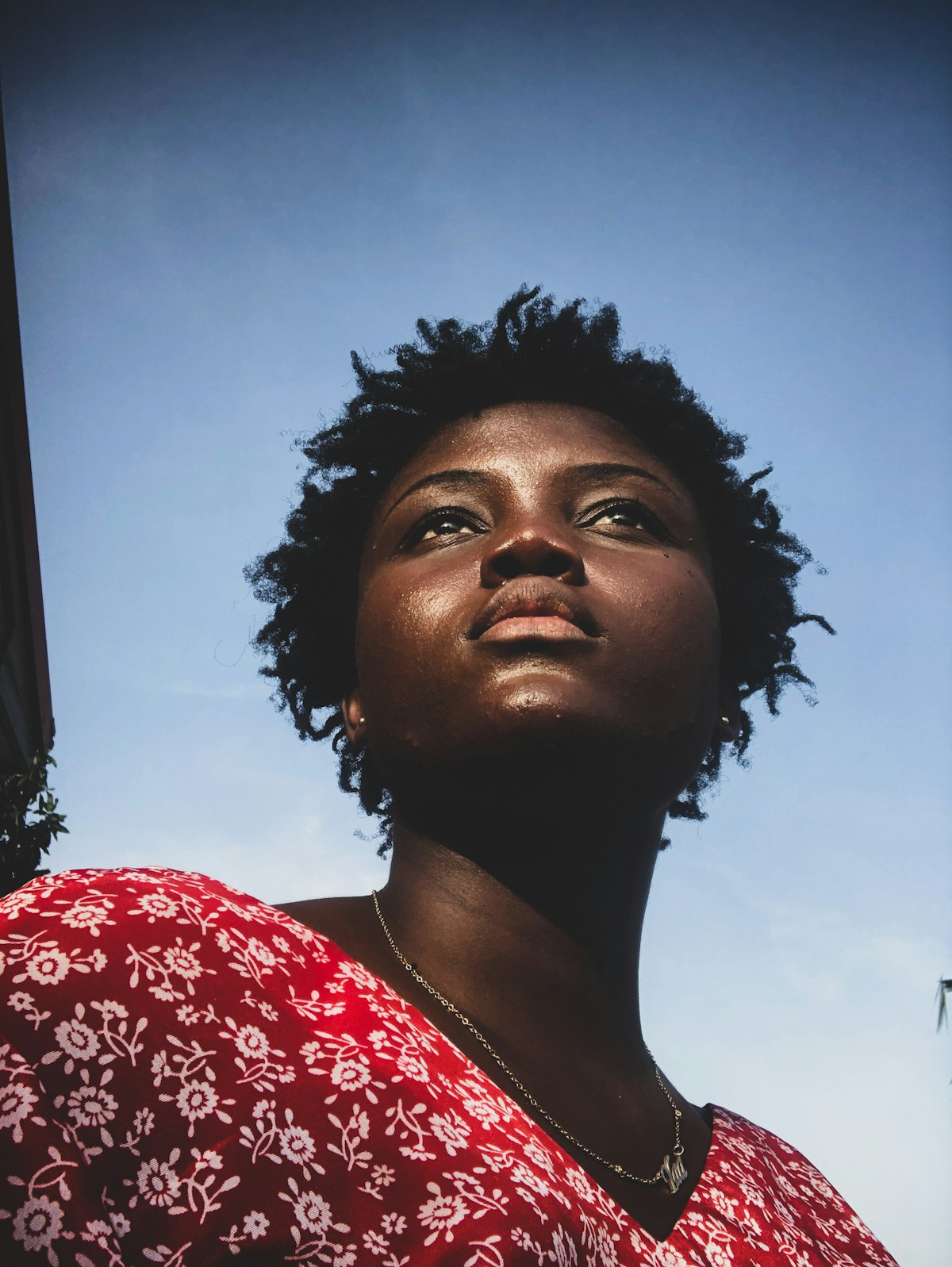 A young woman looking calmly toward the horizon in warm natural light